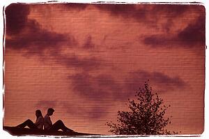 Couple sitting back to back