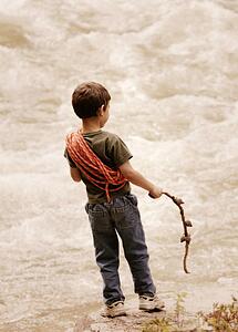 Young boy at edge of torrent