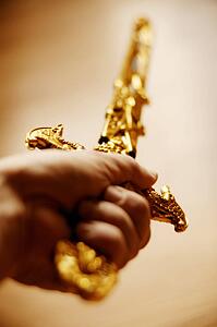 Ornamental sword held aloft
