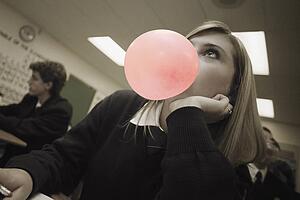 Female student blowing bubblegum