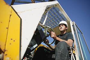 Construction worker using equipment