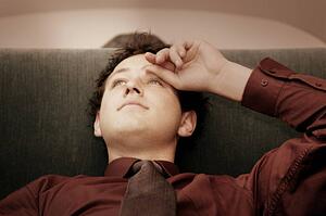 Man laying back on sofa