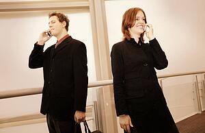Professional couple on cell phones