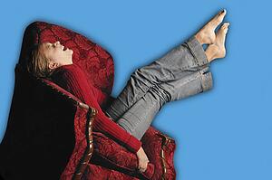 Teenage girl in armchair