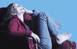 Teenage girl in armchair