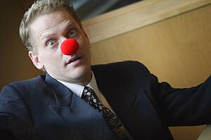 Businessman wearing red nose