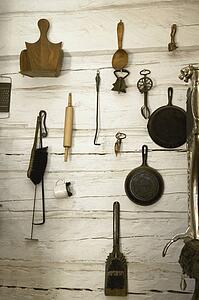 collection of old-fashioned kitchen utensils and implements