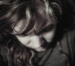 Woman with head down
