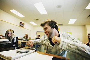 Student listening to music at desk