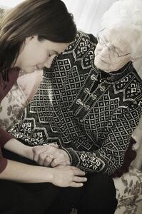 Senior and Woman praying