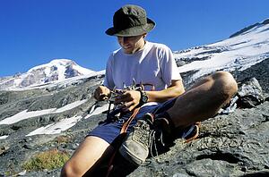 Mountaineer checking equipment