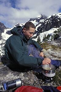 Mountaineer using a camping stove