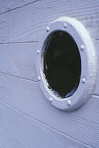 Porthole of wooden boat