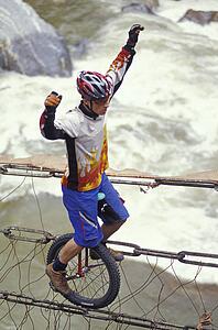 Unicyclist crossing river on unicycle