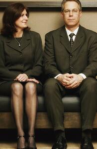 Business couple sitting on bench