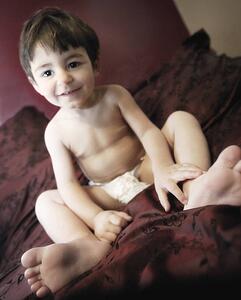 Toddler sitting on bed