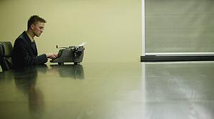 Businessman working on typewriter