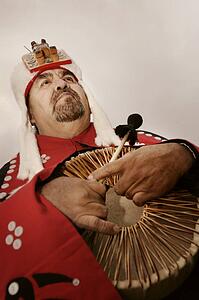 Native American man holding ceremonial drum