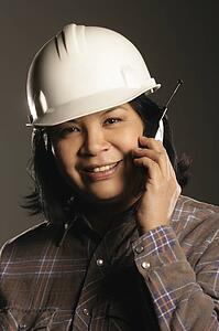 Aboriginal female site worker on cell phone