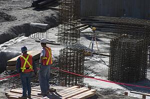 Building site and two construction workers