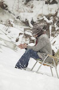 Man sitting in chair in snow