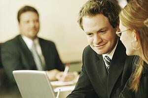 Three people at a business meeting