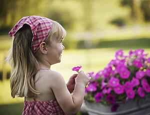 Little girl with pink flower