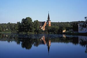Countryside and church reflected in the lake