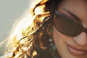 Attractive woman wearing designer sunglasses