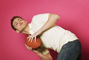 Teen holding football