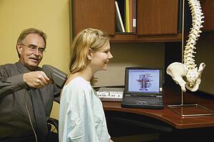 Doctor examining patient's back
