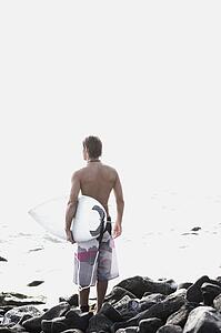 Surfer looking out to sea