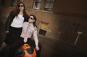 Trendy couple posing on a scooter