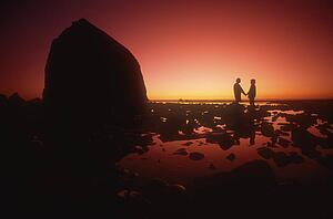 A couple silhouetted against the sunset