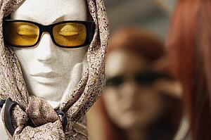 Mannequin head modeling sunglasses and scarf
