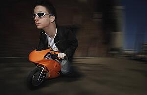 Bizarre image of man riding on a mini motorcycle