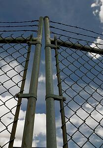 Chain link gate with barbed wire