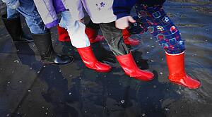 Rubber boots in puddle