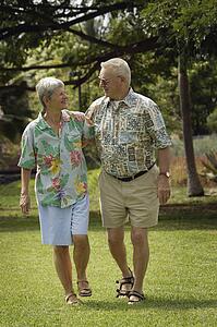 Senior couple walking in field