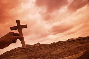Hand holding a cross