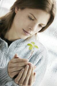 Young woman with new plant