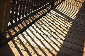 Shadow of wooden railing