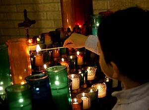 Child lighting candle