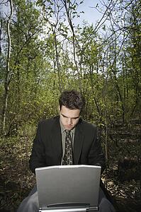 Working on a pc in a woodland glade