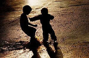 Children pushing in puddle