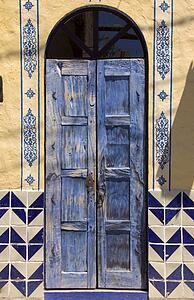 Blue painted door and tiles