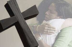 Women hugging, cross