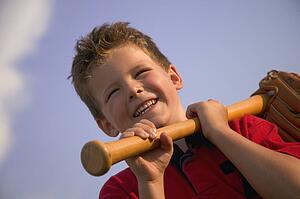 Smiling boy with a baseball bat