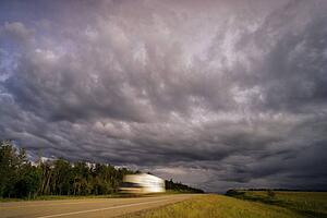 Dark clouds over vehicle on road