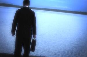 A man alone looking out over water